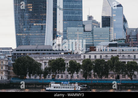 London, UK - June 22, 2019: The Wyndham party boat on River Thames by modern office buildings of the City of London, London's famous financial distric Stock Photo