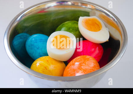 Easter eggs in a bowl, one cut open, ready to eat. Stock Photo