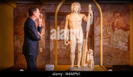 Oxford, UK. 24th July, 2019. LAST SUPPER IN POMPEII exhibition opens at the Ashmolean Museum in Oxford, UK. Dr. Xa Sturgis, Director Ashmolean with Statue of Bacchus AD 50-150 (Roman god of wine and fertility). Credit: Richard Cave/Alamy Live News Stock Photo