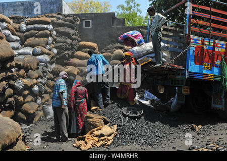 India: Dirty and unhealthy work for men and women - working in the chocole factory Stock Photo