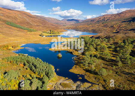 An aerial shot looking east down Glen Cannich from above the Mullardoch hydro electric dam, with Mullardoch House visible to the left. Stock Photo