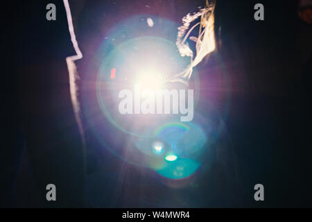 Blurred abstract light with bokeh from spotlight with silhouette. Cinematic lighting natural effect Stock Photo