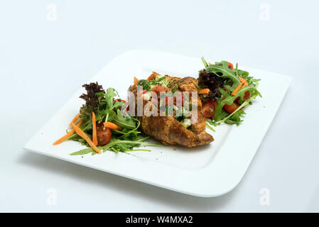 A low contrast Hero shot of a breakfast platter with vegetable-filled croissant with vegetables- carrot, tomato, lettuce on a minimal white background Stock Photo