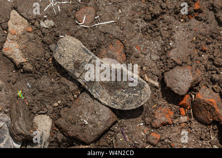 Single shoe left amongst rubble after a building collapsed in Kathmandu after the earthquake in 2015. Stock Photo