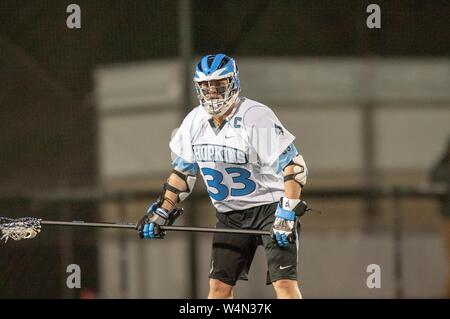 A Johns Hopkins Blue Jays Men's Lacrosse player stands ready with his stick while participating in a game at the Johns Hopkins University, Baltimore, Maryland, February 20, 2009. From the Homewood Photography Collection. () Stock Photo