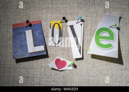 The word LOVE on a bulletin board using cut-out paper letters in the ransom note effect typography Stock Photo