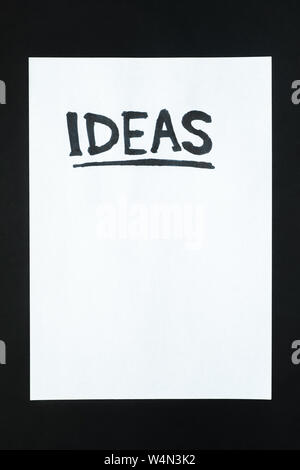 Word "ideas" handwritten on empty paper sheet. Sign, concept of new beginning or planning, abstract illustrative image Stock Photo