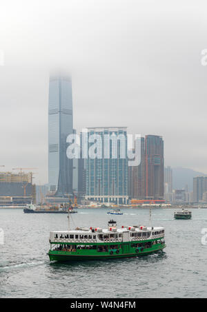 Star Ferry leaving the Central Ferry Terminal on Hong Kong Island with International Commerce Centre in Kowloon behind, Hong Kong, China Stock Photo