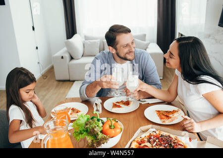 family, mother, father and daughter during dinner.Eating eating homemade pizza at home Stock Photo