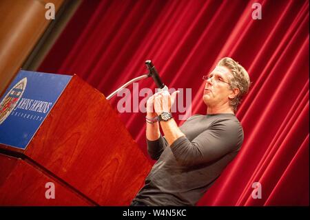 Angled profile view of Donny Deutsch, marketing professional and television personality, speaking at a Milton S Eisenhower Symposium at the Johns Hopkins University, Baltimore, Maryland, November 9, 2010. From the Homewood Photography Collection. () Stock Photo