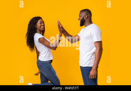 Happy man and woman greeting each other with high five Stock Photo