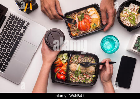 Two collegues having lunch time of healthy food in office Stock Photo