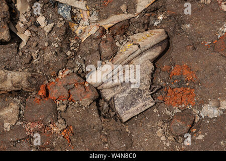 Single boot amongst dirt and rubble following an earthquake in Kathmandu, Nepal Stock Photo