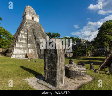 Guatemala, Temple I, or Temple of the Great Jaguar, is a funerary pyramid dedicated to Jasaw Chan K'awil, who was entombed in the structure in AD 734, The pyramid was completed around 740–750 and rises 47 meters or154 feet high, A carved stone stela and altar are in the foreground, Tikal National Park, is an archeological site of the pre-Columbian Maya civilization and since 1979, has been a UNESCO World Heritage Site. Stock Photo