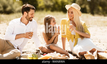 Happy family having picnic, resting in nature Stock Photo