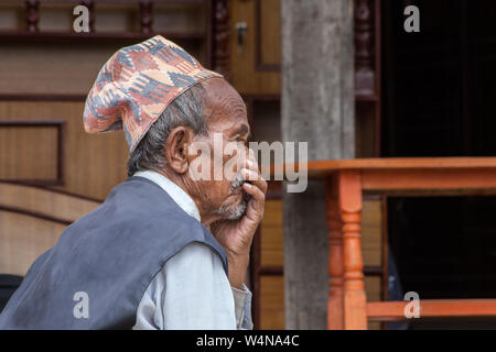 Elderly Nepalese man in thought with his hand to his mouth Stock Photo