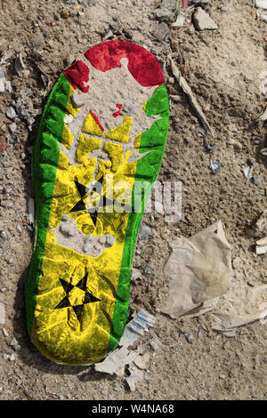 The flag of Sao Tome and Principe is depicted on the sole of an old boot. Ecology concept with environmental pollution from household and industrial w Stock Photo