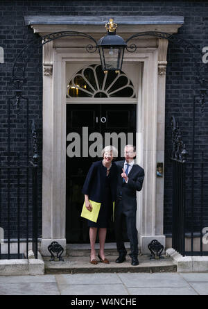 London, UK. 13th July, 2016. File photo taken on July 13, 2016 shows British Prime Minister Theresa May (L) and her husband posing for photos in front of 10 Downing Street in London, Britain. Newly-elected Conservative Party leader Boris Johnson took office as the British prime minister on Wednesday amid the rising uncertainties of Brexit. The latest development came after Theresa May formally stepped down as the leader of the country and Johnson was invited by the Queen to form the government. Credit: Han Yan/Xinhua/Alamy Live News Stock Photo