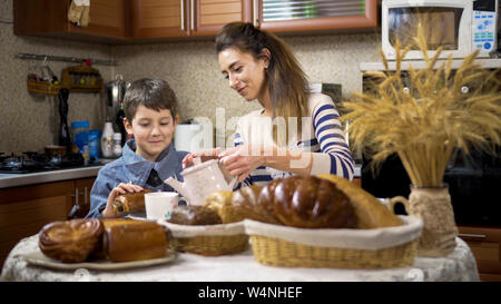 Mom Son Spend Time Holiday Eating Breakfast, mother and boy child on kichen, happy family Stock Photo