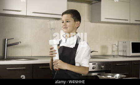 The little boy in a suit of the cook. Baby make dinner in chef suit Stock Photo