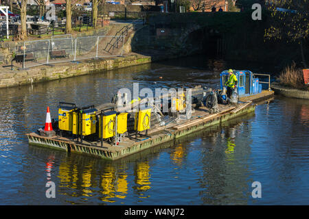 Floating platform with equipment for repairs to lock 92 at the junction of the Bridgewater and Rochdale canals, Castlefield, Manchester, England, UK