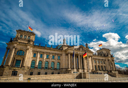 Panoramic view of famous Gendarmenmarkt square with Berlin Concert Hall and German Cathedral in golden evening light at sunset with blue sky and Stock Photo