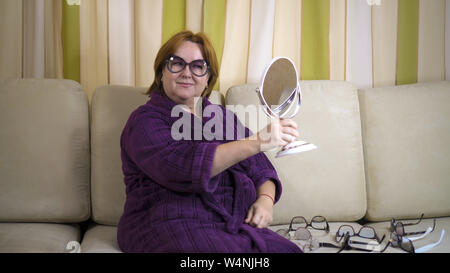 Senior woman choosing between different eyeglasses. Medium shot Stock Photo