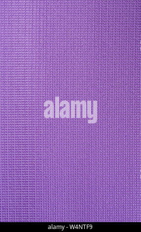 Texture of a violet gym mat. Yoga mat texture. Close up. Stock Photo