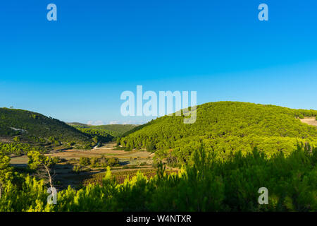 Greece, Zakynthos, Green hills and blue sky nature landscape in dawning atmosphere Stock Photo