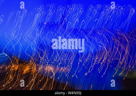Abstract blue and yellow background of unfocused and moved lights. Stock Photo