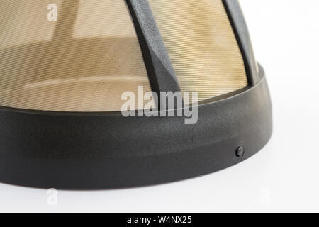 Closeup of reusable metal mesh coffee filter for drip coffee maker. Permanent basket coffee filter on white background. Accessories for coffee machine Stock Photo
