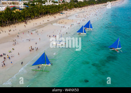 Crowds gathering on Boracay Island's White Beach to watch the sunset. Stock Photo