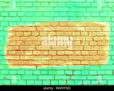 Old brick walls are painted with bright green paint, and the selected fragment is orange. Stock Photo