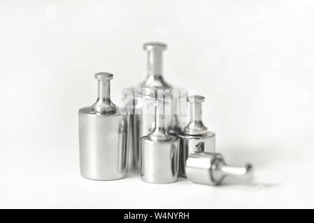 Set of metal weights for scales on white background. For the calibration test. Weight set for calibration balance to accuracy and precision. Apothecar Stock Photo