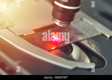 Microscope in medical laboratory analyzing a test sample Stock Photo