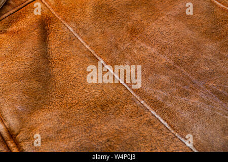 small brown weathered seude jacket closeup texture with selective focus and blur Stock Photo