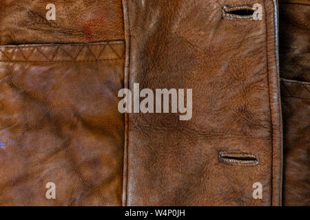 small brown weathered seude jacket closeup texture with selective focus and blur Stock Photo
