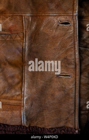 small brown weathered seude jacket closeup texture with selective focus and blur Stock Photo