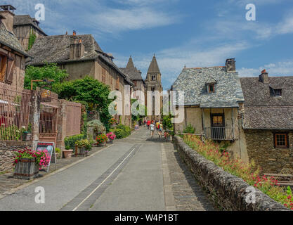 Conques, Midi Pyrenees, France - July 31, 2017: View of Sainte Foy Cathedral at the end of the main street of Conques Stock Photo