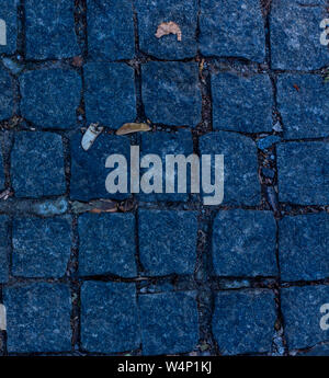 the texture of the road paved with squared stones closeup Stock Photo