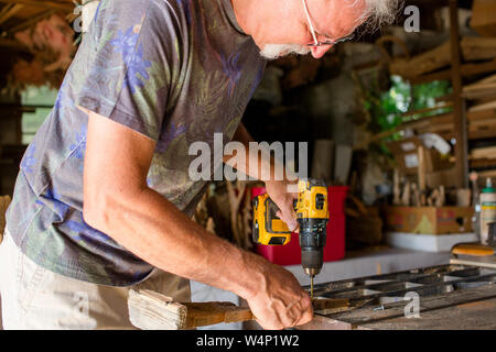 close-up of a woodwork drilling wood at workbench Stock Photo