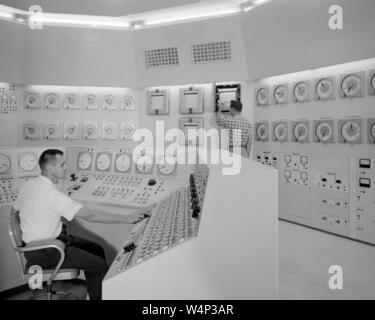 Bill Fecych and Don Johnson work in the reactor control room at the Plum Brook Station, John H. Glenn Research Center at Lewis Field, Cleveland, Ohio, 1959. Image courtesy National Aeronautics and Space Administration (NASA). () Stock Photo