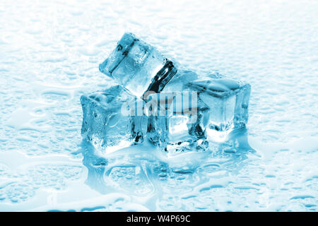 A pile of six ice cubes on a wet background Stock Photo