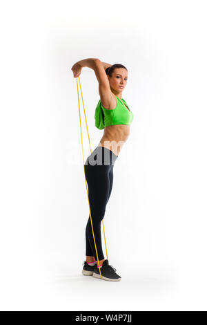 Fitness girl performs exercises with resistance band. Strength and motivation Stock Photo