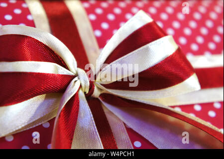 white polka dots. red gift bow close-up. holiday gift close-up. Stock Photo