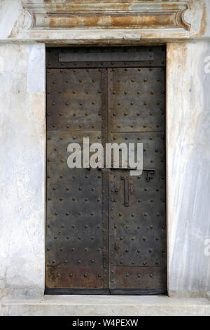 Old closed aged rusty metal door entrance Stock Photo