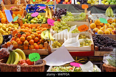 Large selection of fresh organic fruits sold on market stall Stock Photo