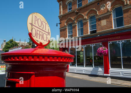 Post Office sign on red postbox, Eton, Berkshire, UK. 23rd July, 2019. The Post Office has now moved to Budgens further up the High Street but daily c Stock Photo