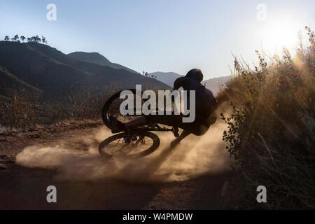 Mature man falling with mountain bike on trail in San Diego, CA Stock Photo