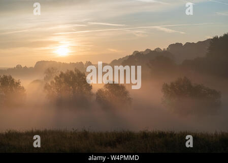 Fog at sunrise at Pewsey Vale, Wiltshire UK Stock Photo